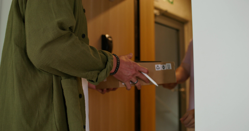 A man receives a delivery at home