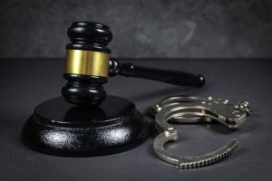 Law concept. Gavel and handcuffs on dark background