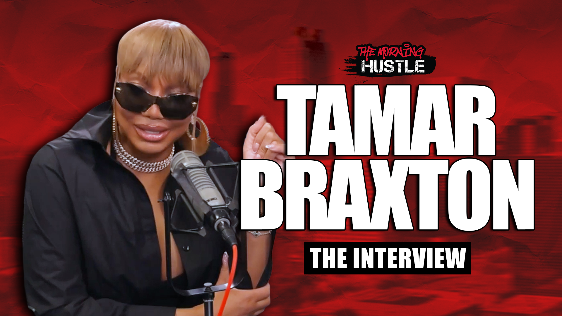 A woman with blonde hair wearing sunglasses and a black outfit speaking into a microphone, with the text "TAMAR BRAXTON THE INTERVIEW" displayed.