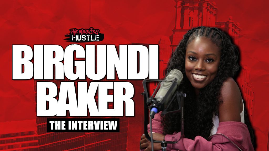 A smiling woman with curly hair speaking into a microphone, with the text "Birgundi Baker The Interview" and "The Morning Hustle" displayed.