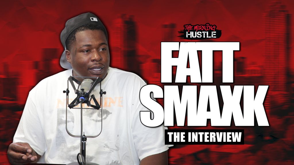 A man wearing a black cap and white shirt speaking into a microphone, with the text "The Morning Hustle" and "Fatt Smaxk The Interview" displayed.